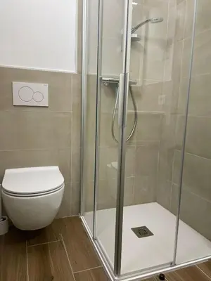 a bathroom with a shower and a toilet at Chalet Scoiattolo Residence Sussy in Falcade