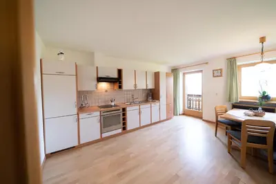 a kitchen with a table and a dining room at Fortschöllhof in Castelrotto