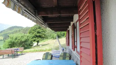a room with a table and a bench on a building at Blasbichler Appartments in Brunico