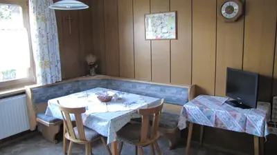 a dining room with a table and a television at Blasbichler Appartments in Brunico
