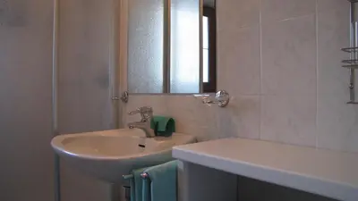 a bathroom with a sink and a mirror at Blasbichler Appartments in Brunico