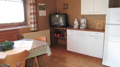 a kitchen with a table and a tv on a counter at Blasbichler Appartments in Brunico