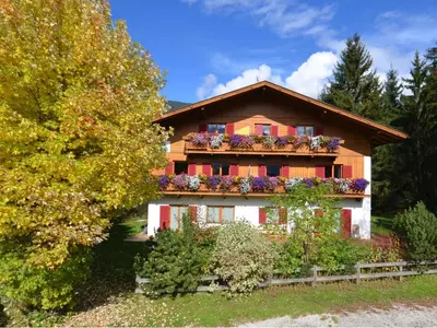 a house with flower boxes on the windows at Residence Veider in Rasùn di Sotto