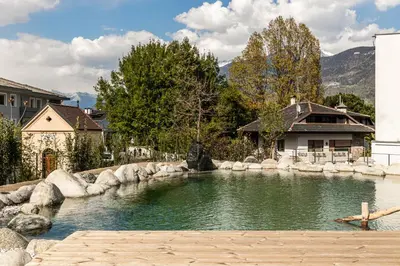 a pool of water in front of a house at Stadele in Lana
