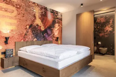 a bedroom with a bed and a painting on the wall at Stadele in Lana