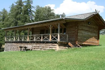 a log cabin in a field of grass at Berghütte Blockhaus in Redagno
