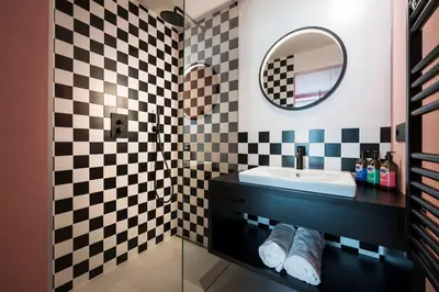 a bathroom with a sink and a mirror at Sport Hotel Passo Carezza in Vigo di Fassa