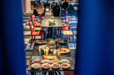 a long table with plates of food on it at Sport Hotel Passo Carezza in Vigo di Fassa