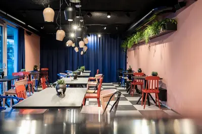 a restaurant with tables and chairs and plants at Sport Hotel Passo Carezza in Vigo di Fassa