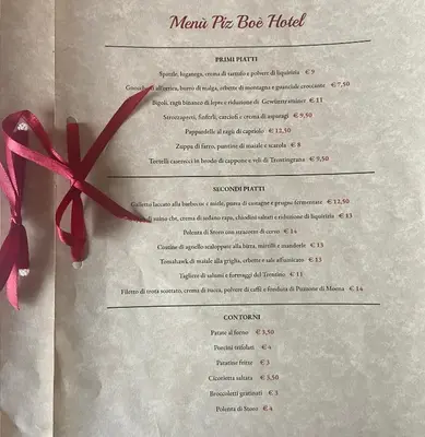 a menu for the boss hotel with a red bow at Hotel Pizboè in Mazzin