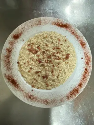 a bowl of rice sitting on a table at Hotel Pizboè in Mazzin