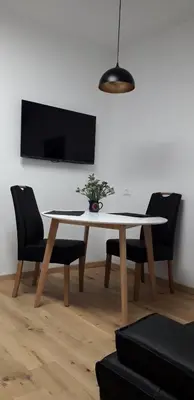 a dining room table with a potted plant on it at Apartment Hagen in Merano