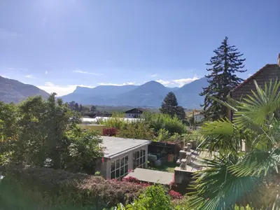 a view of a garden with mountains in the background at Apartment Hagen in Merano