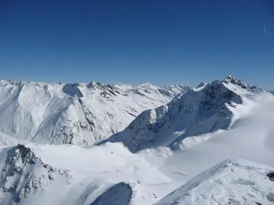 a mountain covered in snow with a blue sky at Apartments Ferdigg in San Lorenzo di Sebato