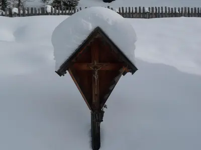 a snow covered street light with a pile of snow on top at Apartments Ferdigg in San Lorenzo di Sebato