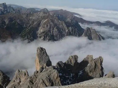 a view from the top of a mountain with clouds at Apartments Ferdigg in San Lorenzo di Sebato