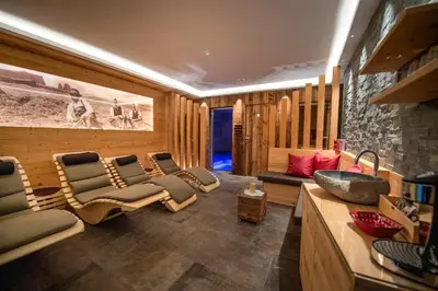 a room with a group of chairs and a sink at Apartments La Rives in Santa Cristina in Val Gardena