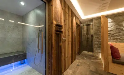 a bathroom with a walk in shower and a glass door at Apartments La Rives in Santa Cristina in Val Gardena