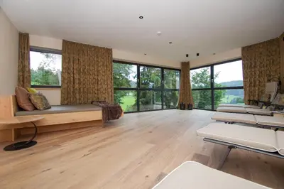 a large living room with large windows and a couch at Apartment Hotel Christine in Avelengo