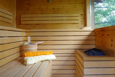 a sauna with a bench in a wooden room at Apartment Hotel Christine in Avelengo