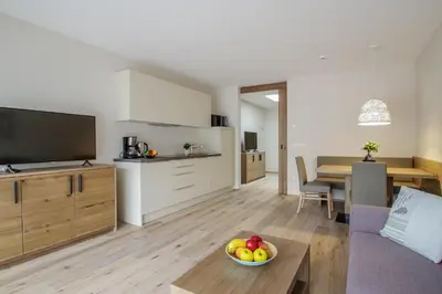 a living room with a couch and a table with a bowl of fruit at Apartment Hotel Christine in Avelengo