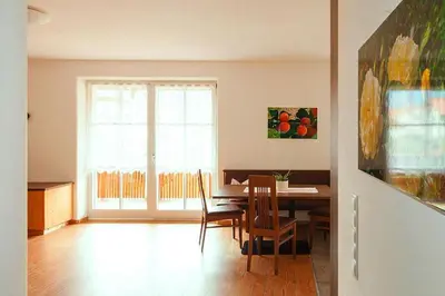 a dining room with a table and chairs and a window at Apartment in Dolomites with Pool Access in Naz-Sciaves