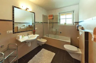 a bathroom with a sink and a toilet and a shower at Apartment in Dolomites with Pool Access in Naz-Sciaves