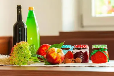 a table with a bottle of wine and some fruit at Apartment in Dolomites with Pool Access in Naz-Sciaves