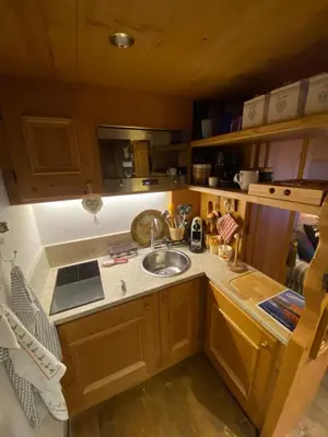 a kitchen with a sink and a counter top at Incantevole monolocale in centro a Cortina. in Cortina dʼAmpezzo