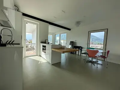 a kitchen and dining room with a table and chairs at Merano Absolute View in Merano