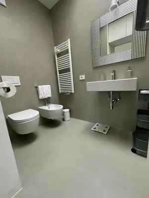 a bathroom with a sink and a toilet and a mirror at Merano Absolute View in Merano