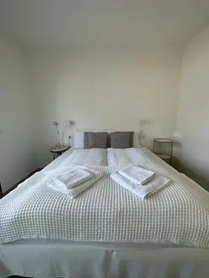 a white bed with two towels on top of it at Merano Absolute View in Merano
