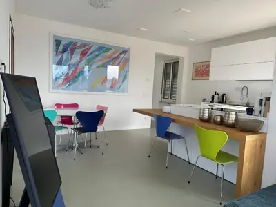 a kitchen with colorful chairs and a table in it at Merano Absolute View in Merano
