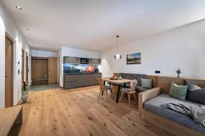a living room with a couch and a table at Trinnerhof- Hof Chalets und Obsthof in Naz-Sciaves