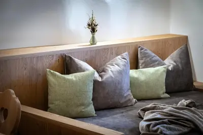 a group of pillows sitting on a bed with aved at Trinnerhof- Hof Chalets und Obsthof in Naz-Sciaves