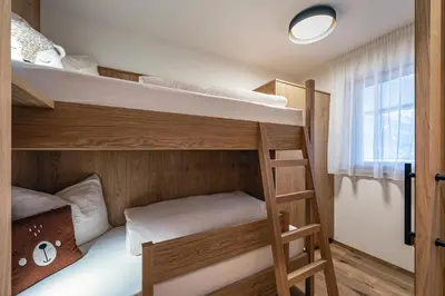 a bunk bed room with two bunk beds at Trinnerhof- Hof Chalets und Obsthof in Naz-Sciaves