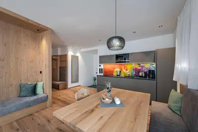 a living room with a table and a couch at Trinnerhof- Hof Chalets und Obsthof in Naz-Sciaves