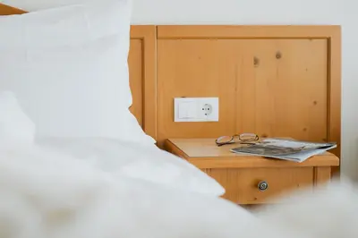 a bedroom with a large bed and a couch at Garni Kleefeld in Schenna