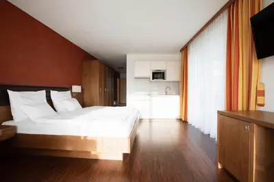 a bedroom with a bunk bed with a ladder at Garni Kleefeld in Schenna