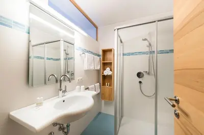 a bathroom with a sink and a shower at Residence Aichner in Brunico