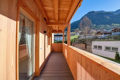 a wooden balcony with a view of a mountain at Apartments Bea in Ortisei