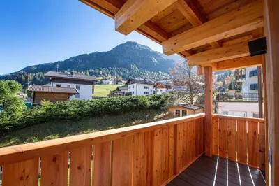 a wooden balcony with a view of a mountain at Apartments Bea in Ortisei