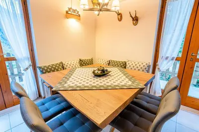 a dining room with a wooden table and chairs at Charming Civetta in Alleghe