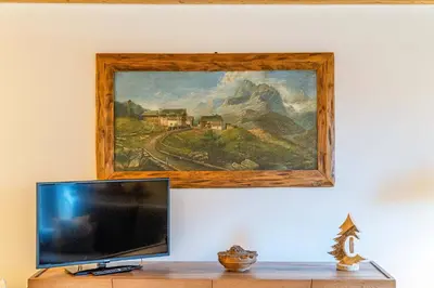 a painting of a train painting on a wall at Charming Civetta in Alleghe