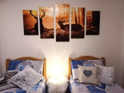 a room with a group of pictures of deer on the wall at Appartamento Valmaor in Predazzo