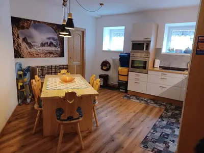 a kitchen and dining room with a table and chairs at Appartamento Valmaor in Predazzo