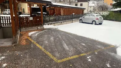 a car parked in a parking lot covered in snow at Appartamento Valmaor in Predazzo