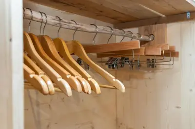 a bunch of wooden bats hanging on a rack at Agritur E-Cinque in Salorno sulla Strada del Vino