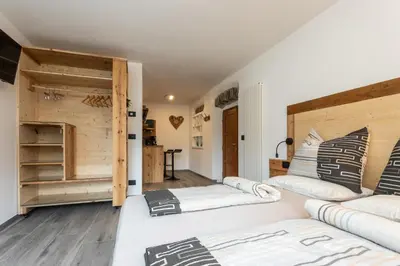 a room with two beds and a closet at Agritur E-Cinque in Salorno sulla Strada del Vino