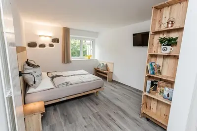 a bedroom with a bed and a book shelf at Agritur E-Cinque in Salorno sulla Strada del Vino